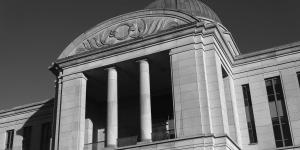 Outside of a courthouse with pillars black and white
