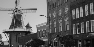 black and white of buildings with a windmill in the top left section