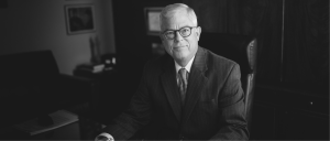 Guy Cook sitting in black and white