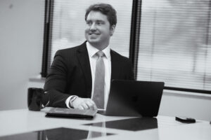 Ben Erickson smiling while working with his laptop